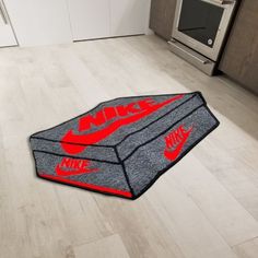 a kitchen area rug with the word nike on it in red and grey colors, next to an oven