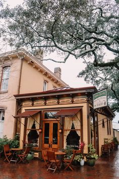 the outside of a restaurant with tables and chairs