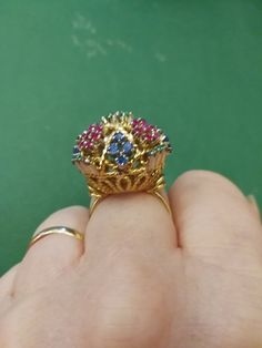 "Beautiful, unique, outrageous vintage18K multi stone ring. There is no karat stamp, but has been tested as 18K. It weighs 14.8 grams, and is set with the following approximate weights of stones: .30 ctw genuine emeralds, .59 ctw genuine sapphires, and .70 ctw genuine rubies. It is between a size 7 1/2 and 8. It has \"bumps\" inside the ring which leave a small gap, when measuring it in a mandrel. There is one flaw in the ring. There is a missing emerald, due to a broken prong. I have this area Multicolor Ruby Ring For Formal Occasions, Multicolor Sapphire Ring With Prong Setting For Formal Occasions, Formal Multicolor Sapphire Ring With Prong Setting, Yellow Gold Multi-stone Ruby Ring, Unique Multi-stone Ruby Ring In Yellow Gold, Multi-stone Ruby Ring In Yellow Gold, Formal Multicolor Rings With Prong Setting, Multicolor Cluster Ring For Formal Occasions, Multicolor Heirloom Rings For Formal Occasions