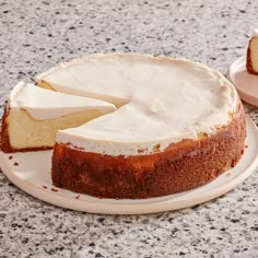 a cake sitting on top of a white plate next to a piece of cake with one slice missing