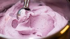 a metal bowl filled with pink ice cream