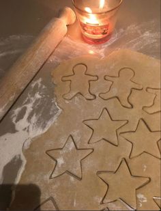 some cookies are laying on a table next to a candle