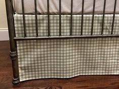 a black and white checkered crib bedding with a wooden floor in the background