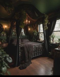 a bedroom with a canopy bed and lots of greenery on the walls, along with potted plants