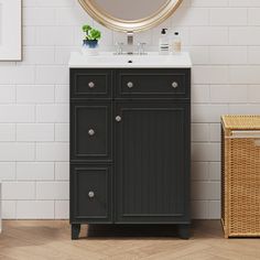 a bathroom vanity with a round mirror above it and a wicker basket next to it