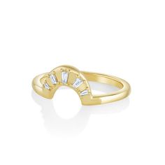 a yellow gold ring with three baguettes on the top and side, set in white