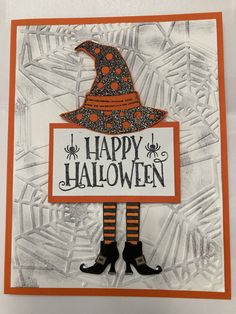 a handmade halloween card with a witch's hat and legs on the front