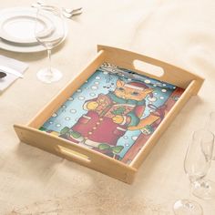 a wooden tray with an image of a cat on it sitting on top of a table