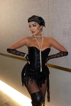 a woman in a black corset and pearls