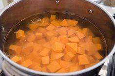 the food is being cooked in the pot on the stove