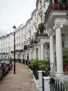 a row of white houses with black balconies