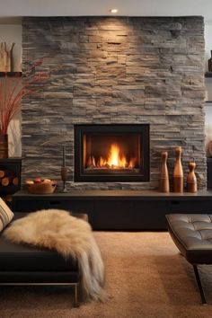 a living room with a fire place and couches in front of the stone fireplace