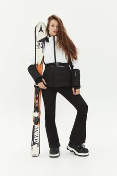 a woman is posing with her skis and snowboard