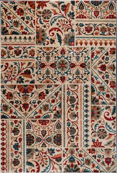 an old rug with many different designs and colors on the carpet, including red, blue,