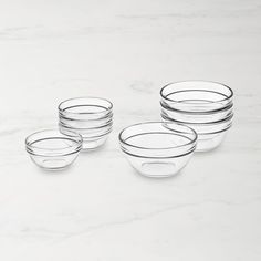 six clear glass bowls on a marble surface