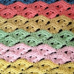 a crocheted blanket is shown with different colors