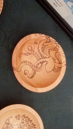 two wooden plates with intricate designs on them