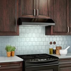 a black stove top oven sitting in a kitchen next to wooden cabinets and white counter tops