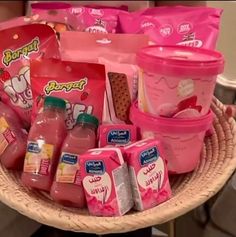 a basket filled with lots of different types of juices and condiments on top of a table