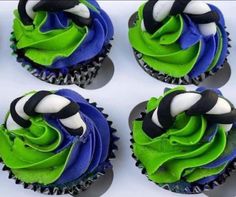 four cupcakes with green and blue frosting