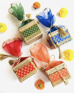 six colorful bags with tassels and flowers around them