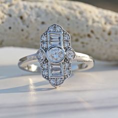 a diamond ring sitting on top of a white table