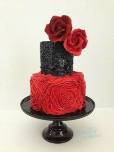 a red and black wedding cake with roses on top is featured on pinterest