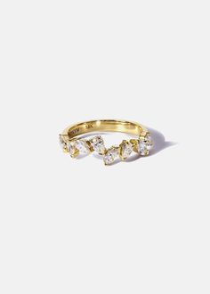 a yellow gold ring with three small diamonds on the top and one smaller diamond in the middle