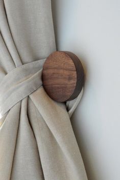 a curtain with a wooden button on it