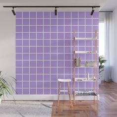 a living room with purple tiles on the wall and wooden flooring in front of it