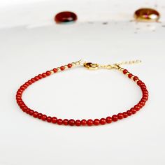 "Minimalist, wearable and delicate 14k gold filled and red jasper bracelet for everyday wearing. Length: from 5,5\" to 8\" with 1\" 14k gold filled extensor chain. Width: 2mm 14k gold filled beads and red jasper beads. Material: 14k gold filled strong lobster clasp. Handmade in Spain. ✩ Please kindly note that these stones are natural so they can vary slightly in color from the one on the pics. They can also contain some inclusions. ✩ Ideal for a gift to gold jewelry lovers. All our products are Red Jasper Bracelet, Red Beaded Bracelet, Jasper Bracelet, Bracelet Crystal, Birthstone Bracelet, March Birthstone, Birthstone Bracelets, Moonstone Jewelry, Jasper Beads