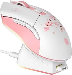 a pink and white computer mouse with flowers on it