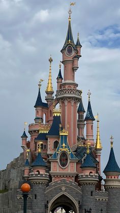 the castle is pink and blue with gold trim