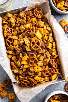 a tray filled with cheetos and pretzels on top of a table