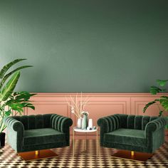 two green velvet chairs in front of a checkered floor with potted plants on the side table