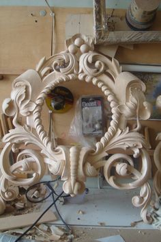 an ornate wooden frame is being worked on