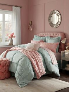 a bedroom with pink walls and blue bedding