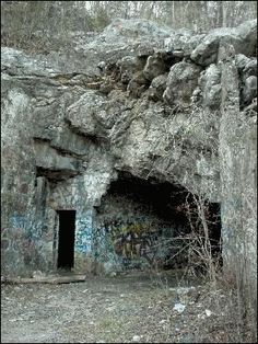 an old cave with graffiti on the walls