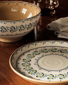 two bowls sitting on top of a wooden table