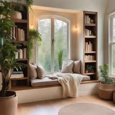 a window seat with bookshelves and plants in it