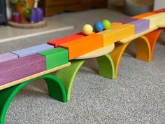 a colorful wooden bench sitting on top of a carpeted floor