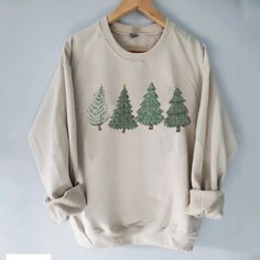 "Christmas Trees, Holiday Pine Trees Digital Printed on a crewneck Sweatshirt.  These are unisex size sweatshirts.  It takes 1-2 weeks to make and process orders for shipping.  If you require it SOONER, you will need to purchase the \"rush order add-on\" Printed design will be as shown as in the picture.   Item Description: Unisex Men Sizing   Gilden Pull On Long Sleeve Crewneck No returns or exchanges on custom items.  Please contact me with any concerns on your order." Winter Pullover, Trendy Winter, Comfortable Sweater, Estilo Chic, Sweatshirts Pattern, Polyester Yarn, Pine Trees, Denim Overalls, Winter Sweaters