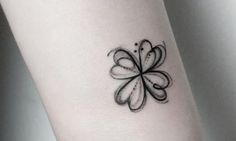 a black and white flower tattoo on the left wrist, with an arrow in the center