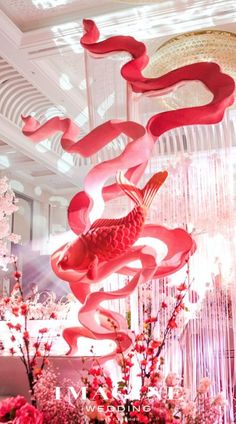 a room filled with lots of pink flowers and decorations