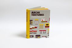 an open book with geometric designs on the front and back cover, sitting on a white surface