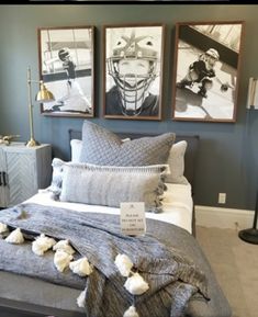 a bed room with a neatly made bed and two pictures on the wall above it