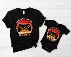 Leveled Up to Daddy Player 2 Has Entered the Game Shirt, Fathers Day Matching Shirt, Fathers Day Gift, Gamer Dad Gift, Daddy and Baby Outfit HOW TO ORDER: 1.) Please check the photos and listing descriptions.  2.) Select Your items color from the drop down menu. 3.) Select your desired quantity for the item. 4.) Please Specify your design color for your shirt in the box that says "Add Your Personalization". 5. Click ADD TO CART. (You can then repeat the steps anytime you want to and add more col Christmas Gifts For Grandma, Family Shirts Matching, Gaming Shirt, Fathers Day Shirts, Baby Outfit, Matching Shirts, Personalized T Shirts, Dad To Be Shirts, Family Shirts