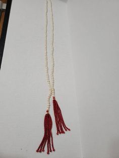 "An extra long freshwater pearl necklace with dyed red jade tassels and a toggle clasp. Red jade is a little deeper than it appears in photos, more brick red. We have a pink version of the necklace, also (see last photo). ●Length: 37\" plus a 5\" drop on the tassels ●Linda's Designers Group features a collection of unique china, luxury estate sale handbags, vintage statement jewelry and handmade 'one of a kind' jewelry. We will gladly provide additional images or information, contact us through Red Tassel Necklace For Gift, Red Tassel Necklaces For Gifts, Red Tassel Necklaces As Gifts, Elegant Red Long Necklace With Round Beads, Elegant Red Mala Beads, Elegant Red Mala With Round Beads, Elegant Red Mala, Elegant Hand-strung Mala As Gift, Judith Leiber Handbags