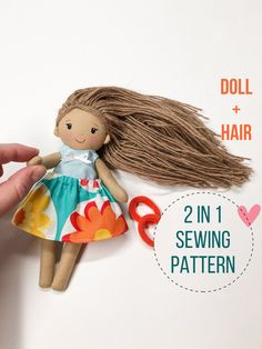 the doll has long hair and is wearing a dress