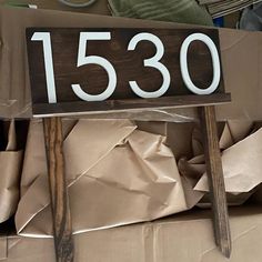 a house number sign sitting on top of cardboard